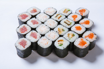 A plate with different kinds of sushi and rolls
