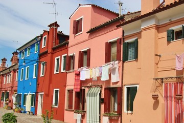 Fototapeta na wymiar Bright colored houses and laundry hung up to dry on the island Burano, situated in the Lagoon of Venice, Italy, Europe. 