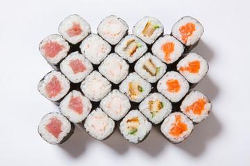 A plate with different kinds of sushi and rolls