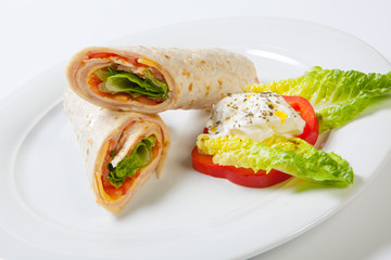 Rolls from pita bread stuffed with salad cheese ham and vegetables