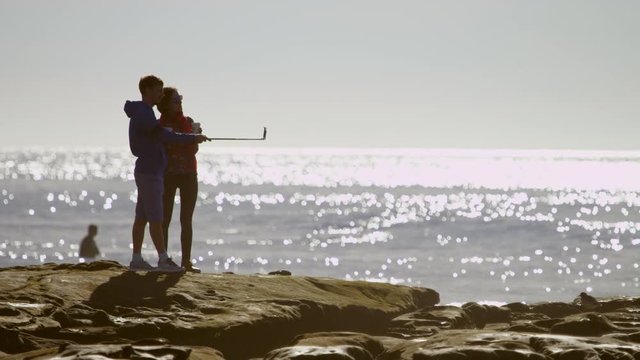 Young couple is taking a self shot on a beach