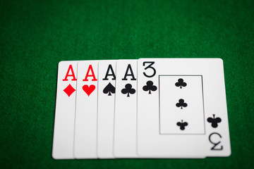 poker hand of playing cards on green casino cloth