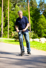 Old man riding scooter