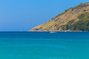 Fototapeta premium Mountains over transparent ocean water