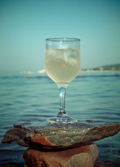 Glass of white wine by the coast