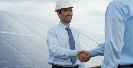 Two technical expert partners in solar photovoltaic panels, remote control performs routine operations to monitor the system using clean, renewable energy. The concept of remote support technology. © Kitreel