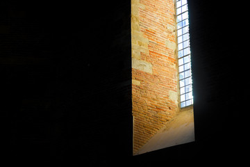 Old mediavel window with brick and stone wall - concept image with copy space on black background