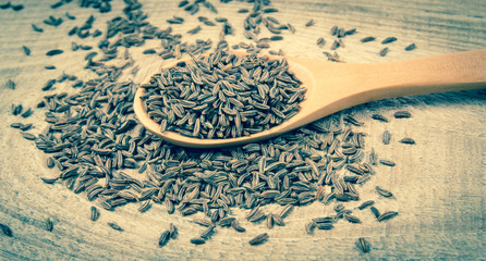 Cumin in a spoon . Close Up .