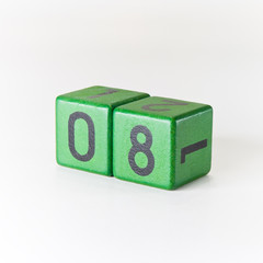Number eight written on a wooden green cube