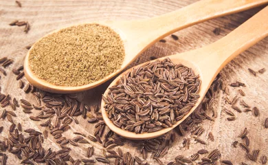 Poster Ground cumin in a spoon and whole cumin © morissfoto