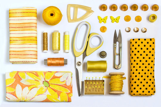 Various sewing accessories and tools yellow shades