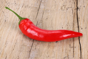 red hot chili pepper on old wood background