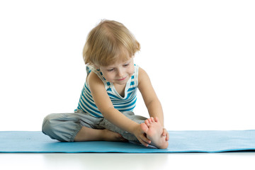 Child practicing yoga, stretching in exercise wearing sportswear. Kid isolated over white background