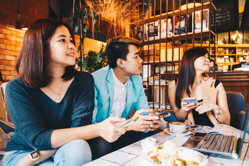 Group of asian business people working at laptop In vintage loft cafe