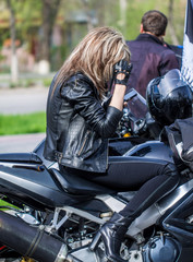Fototapeta na wymiar Girl biker in a leather jacket