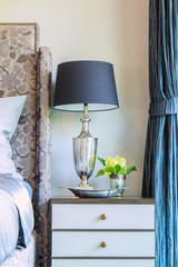 abstract lamp on head of bed in bedroom