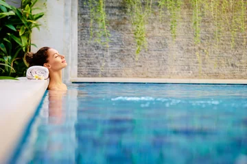 Fotobehang Beauty and body care. Sensual young woman relaxing in outdoor spa swimming pool. © luengo_ua