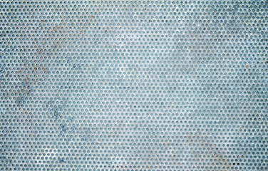 Metal sheet with holes as background