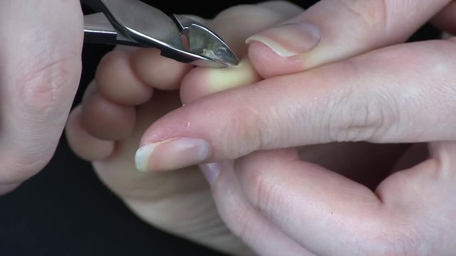 Scissors Cut Cuticles and Nails on Toes Fingers At Little Girl. Mother Makes Pedicure of a Daughter After Bathing Cutting Nails with Scissors. Mother Has Cut The Baby Nails