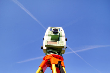 Total station with blue sky in the background. Survey Instrument geodetic device, total station set...