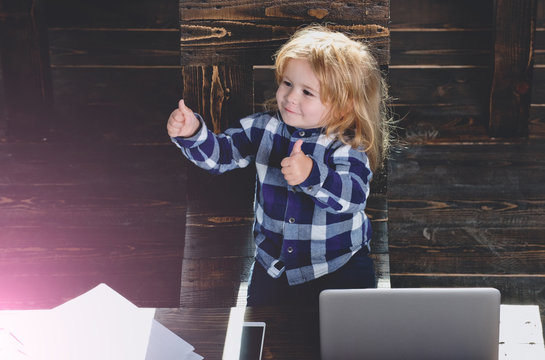 Happy Boy Kid In Office With Laptop, Phone, Paper Sheet