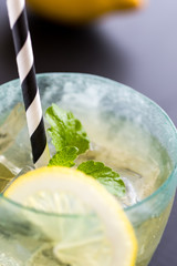 Cold Lemonade With Ice Cubes and Lemon on Dark Background