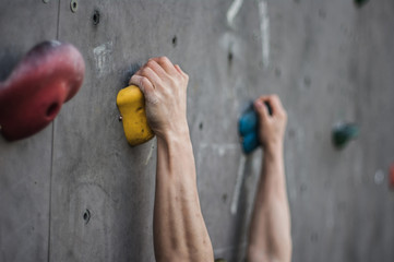 Close-up of asian male Climbing focus on hands 