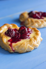 Vanilla Cream and Fruit Berry Puff Pastry Dessert on Blue Background