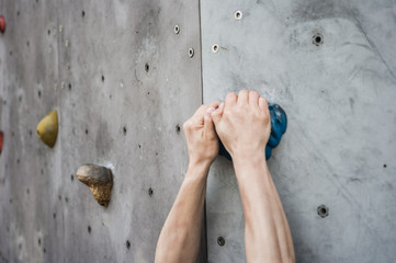 Close-up of asian male Climbing focus on hands 