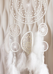 white dream catcher with feathers for home decor and coziness in the house