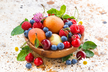 bowl with seasonal fruit and berries, closeup top view