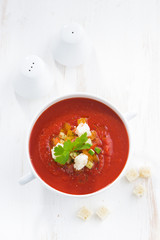fresh gazpacho with croutons in a bowl, top view