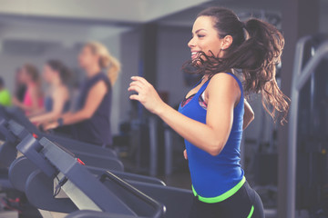 Beautiful brunette on a treadmill