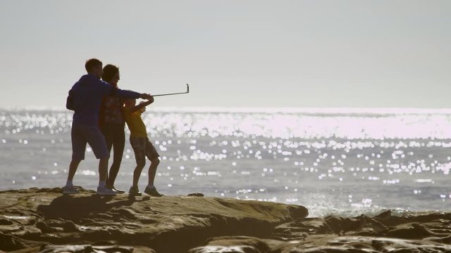 Happy family is making a selfshot on a beach