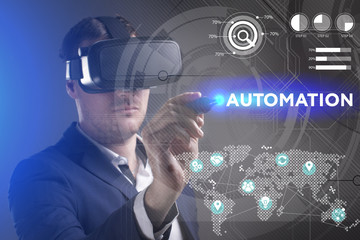 Business, Technology, Internet and network concept. Young businessman working in virtual reality glasses sees the inscription: Automation