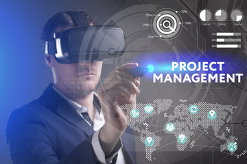 Business, Technology, Internet and network concept. Young businessman working in virtual reality glasses sees the inscription: Project management