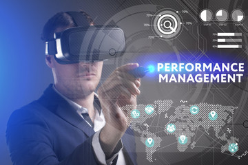 Business, Technology, Internet and network concept. Young businessman working in virtual reality glasses sees the inscription: Performance management