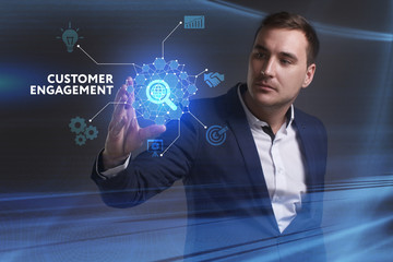 Business, Technology, Internet and network concept. Young businessman working on a virtual screen of the future and sees the inscription: Customer engagement