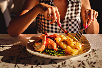 Woman cutting potato at the lunch