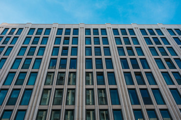 Fototapeta premium big office building with small blue windows
