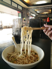 Noodles.  Chopsticks holding noodles