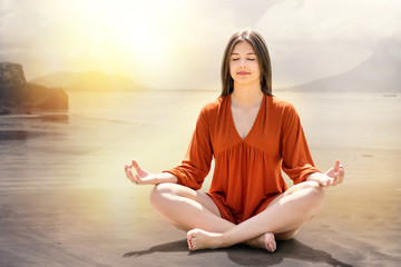 Fototapeta premium Young woman meditating at riverside.