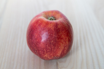Beautiful red apple on a  wooden background