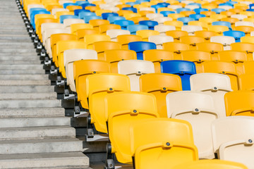 Fototapeta premium rows of yellow and blue stadium seats and stadium stairs