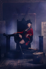 Beautiful woman trainer in a circus suit on the throne