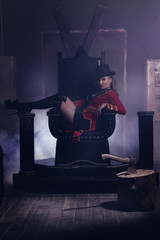 Beautiful woman trainer in a circus suit on the throne