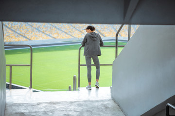 african american young sportswoman standing at handrail on stadium