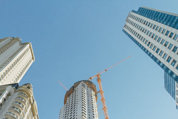 Three towers of apartments under construction seen from below