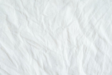 Naklejka na ściany i meble Wrinkled white cotton fabric texture background, wallpaper