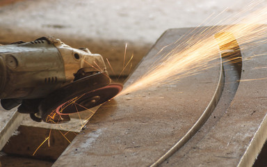 Erectric wheel grinding on steel material. Close up view.